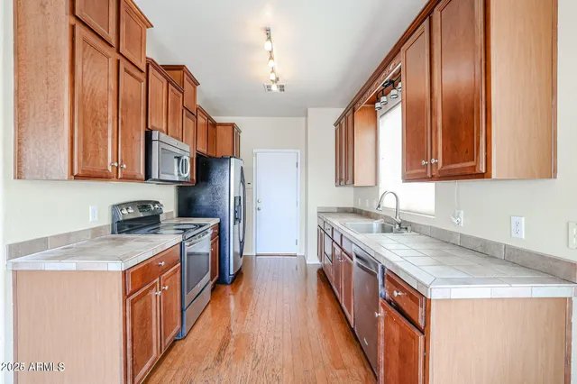 a kitchen with a stove top oven sink and cabinets