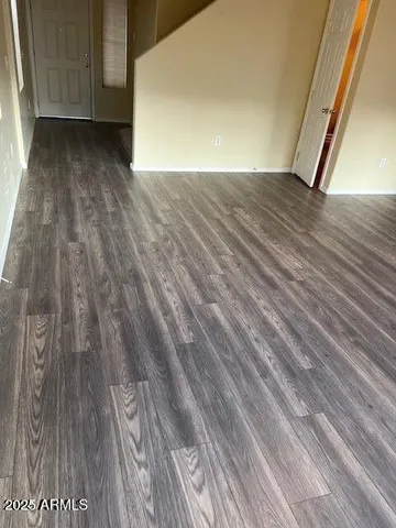 a view of a room with wooden floor