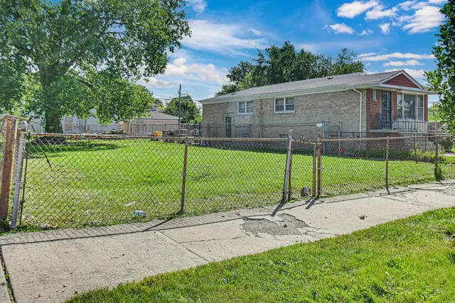 a view of a house with backyard and a garden