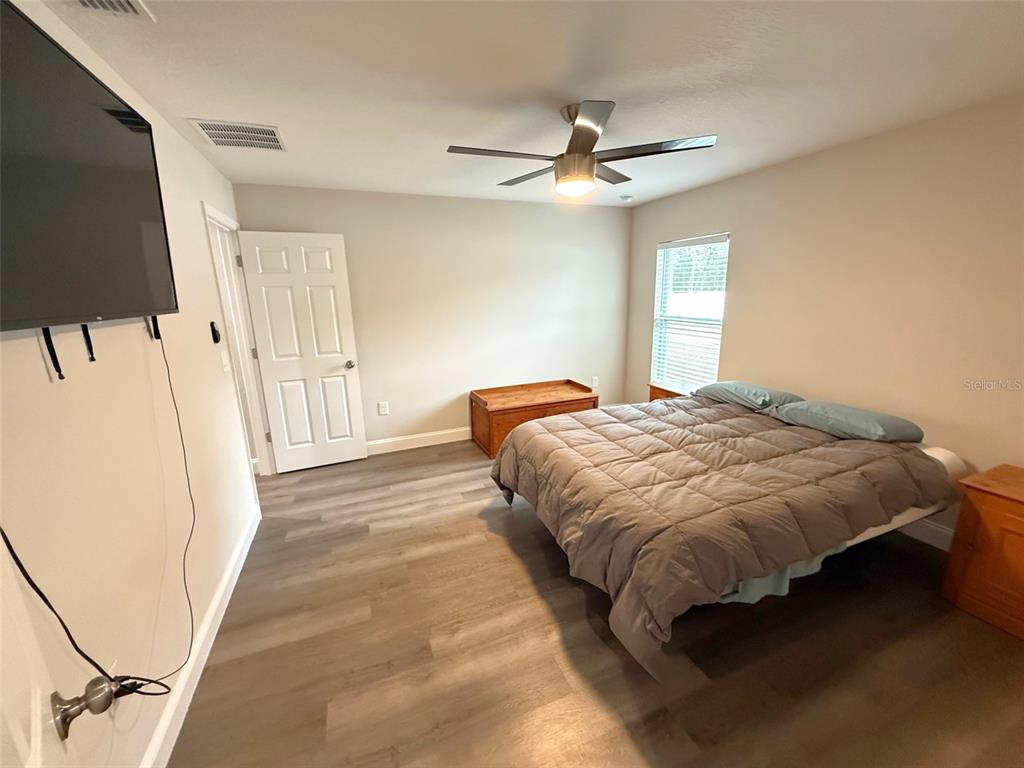 3791 Southwest 166th Pl Road Ocala, FL 34473 - Photo 12 of 43 a spacious bedroom with a bed and a window