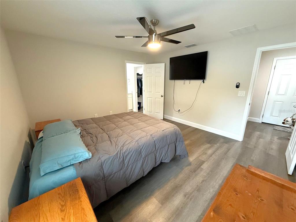 3791 Southwest 166th Pl Road Ocala, FL 34473 - Photo 13 of 43 a bedroom with a bed and a flat screen tv