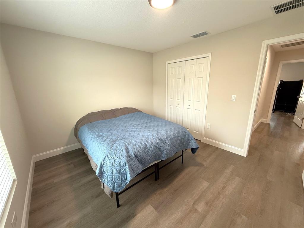 3791 Southwest 166th Pl Road Ocala, FL 34473 - Photo 19 of 43 a bedroom with a bed and flat screen tv