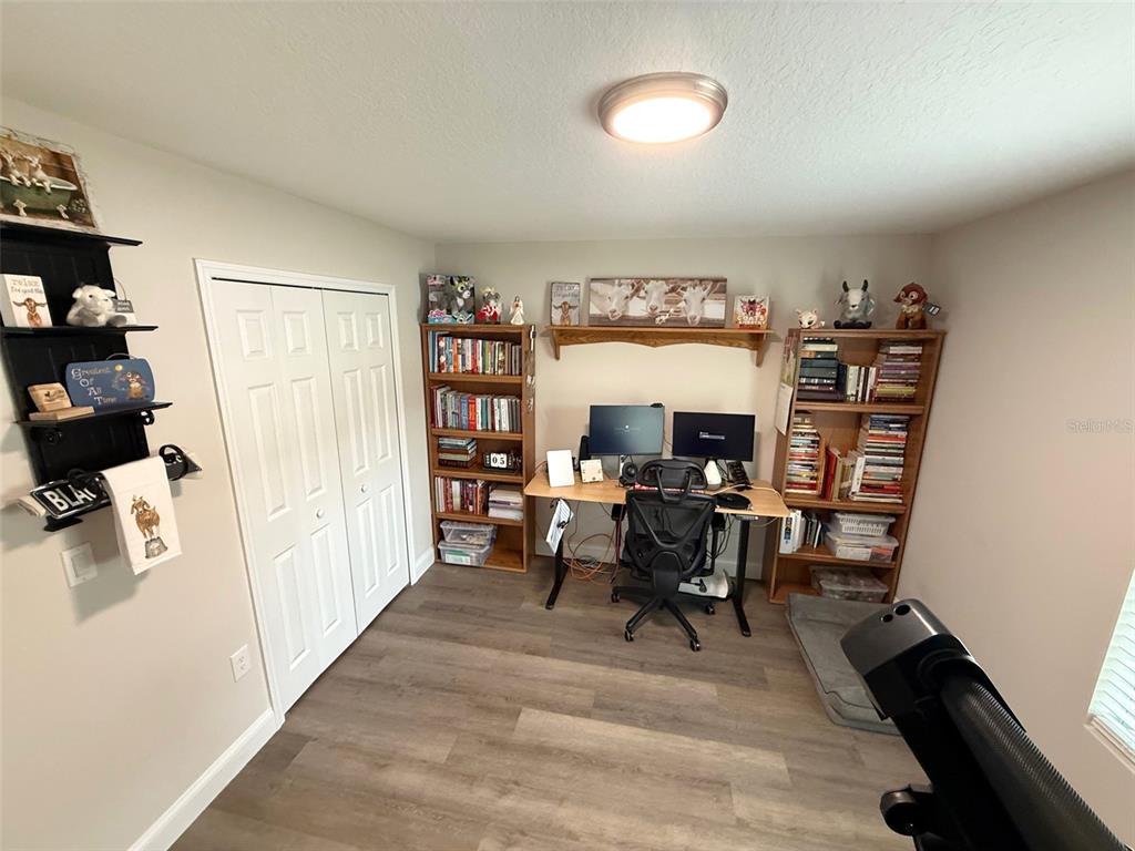 3791 Southwest 166th Pl Road Ocala, FL 34473 - Photo 22 of 43 a view of a workspace with furniture and a bookshelf