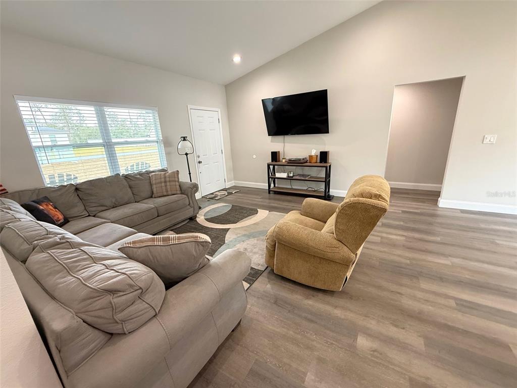 3791 Southwest 166th Pl Road Ocala, FL 34473 - Photo 4 of 43 a living room with furniture and a flat screen tv