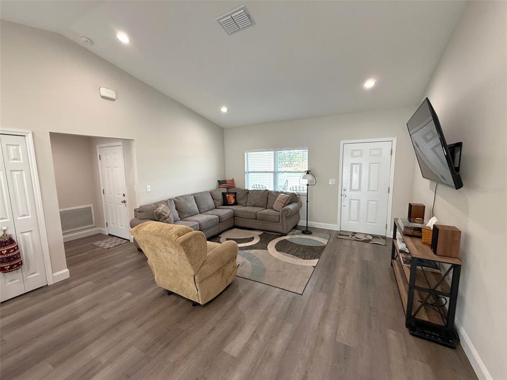 3791 Southwest 166th Pl Road Ocala, FL 34473 - Photo 5 of 43 a living room with furniture flat screen tv and wooden floor