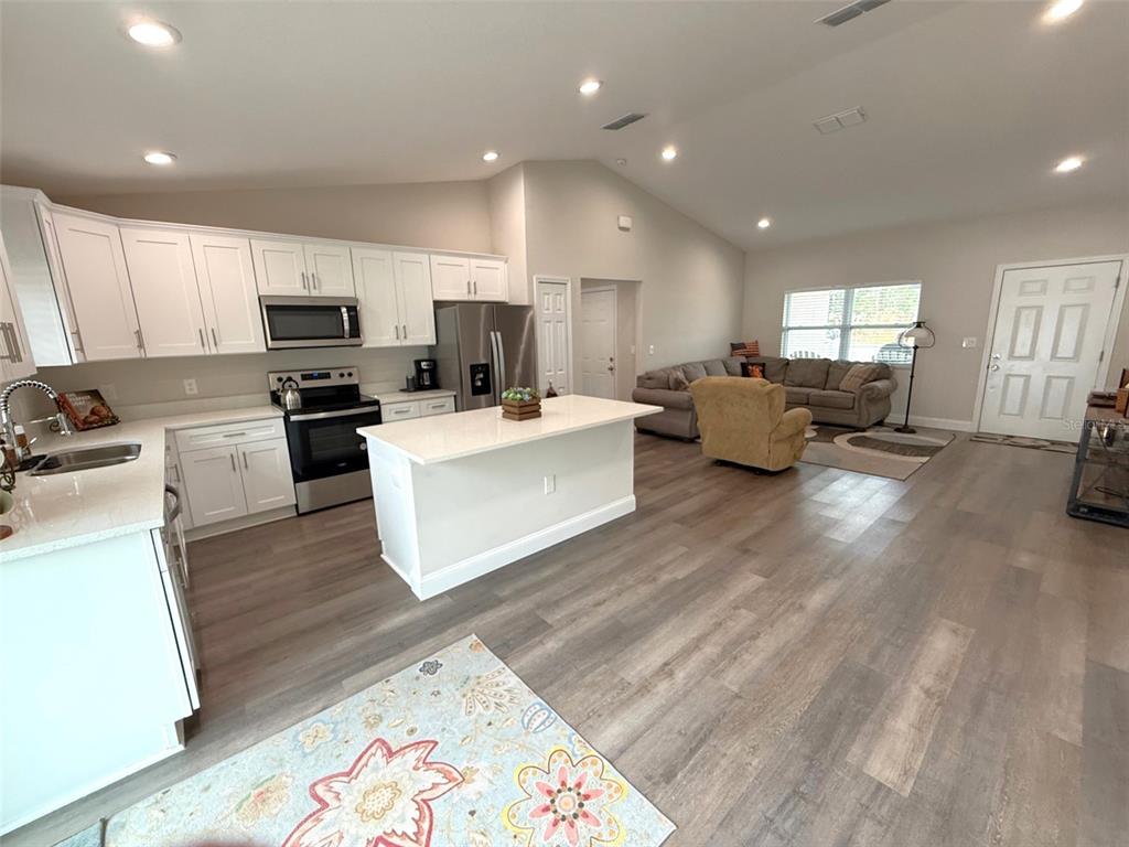 3791 Southwest 166th Pl Road Ocala, FL 34473 - Photo 8 of 43 a living room with furniture and a wooden floor