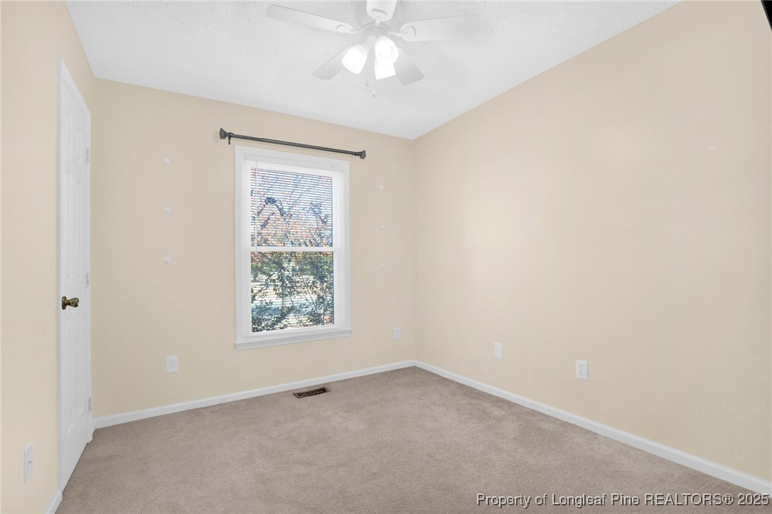 101 2 Hours Court Raeford, NC 28376 - Photo 16 of 30 an empty room with a window and a ceiling fan