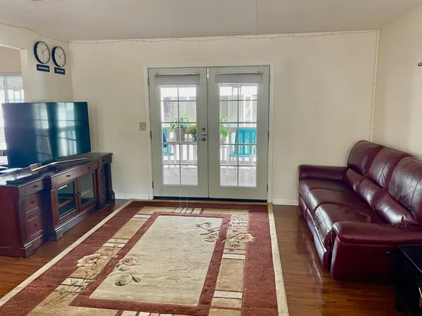 a living room with furniture rug and a flat screen tv