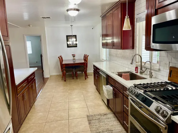 a kitchen with a stove a sink and a microwave
