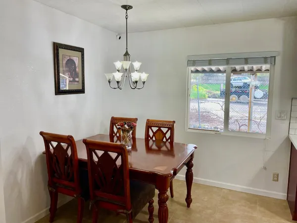 a view of a dining room with furniture window and outside view