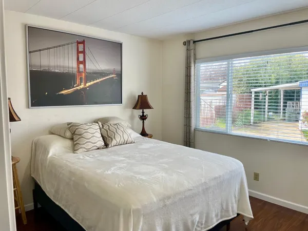 a bedroom with a large bed and a large window