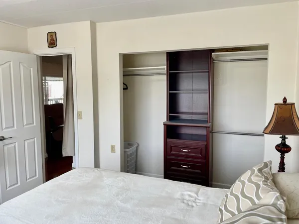 a bedroom with a bed and a cabinets