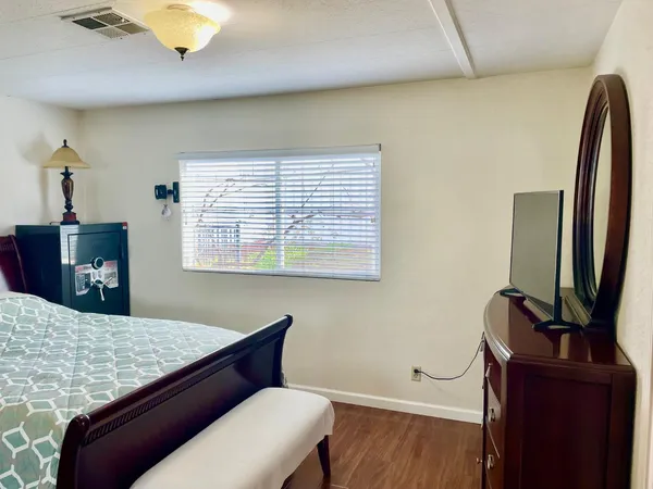 a living room with a bed furniture and a window