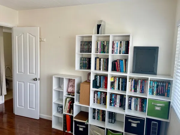 a living room with furniture and a book shelf