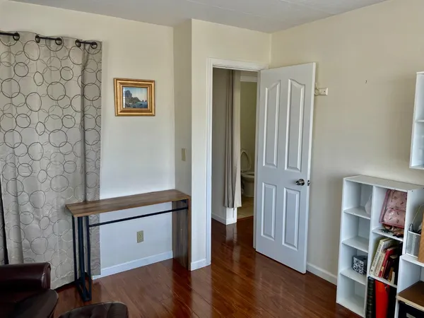 a view of a room with wooden floor and closet