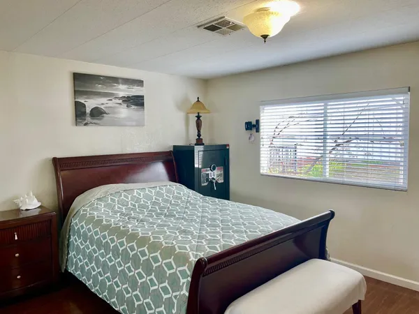a bedroom with a large bed and a dresser