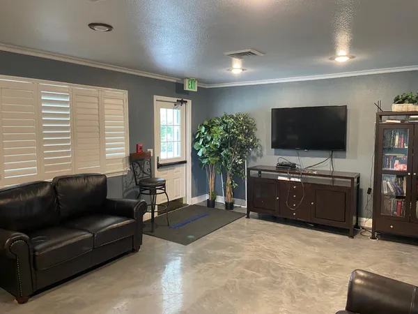 a living room with furniture and a flat screen tv