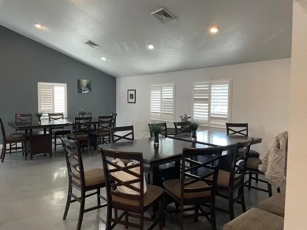 a view of a dining room with furniture and window