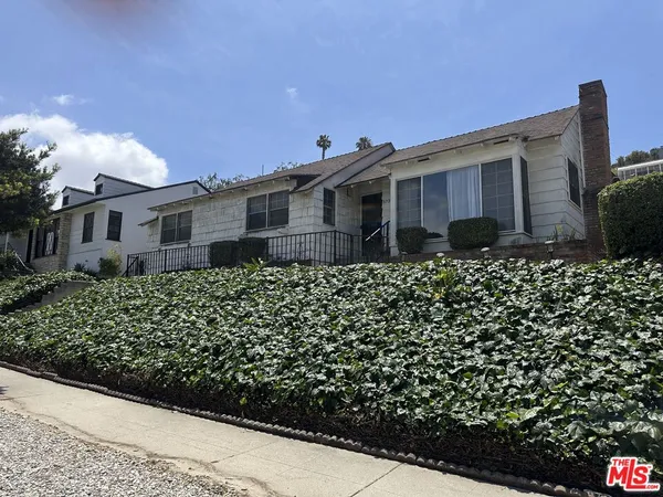 a view of a house with a flower garden