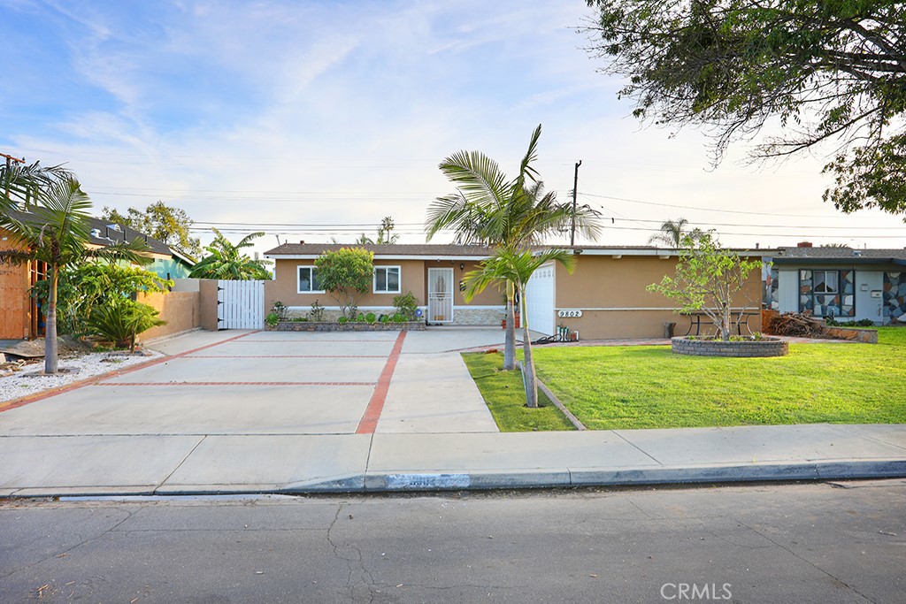 9802 Chanticleer Road Anaheim, CA 92804 - Photo 1 of 31 a view of a house with a yard and palm trees