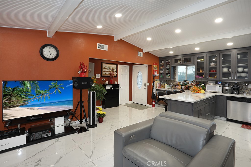 9802 Chanticleer Road Anaheim, CA 92804 - Photo 14 of 31 a living room with stainless steel appliances kitchen island furniture and a flat screen tv