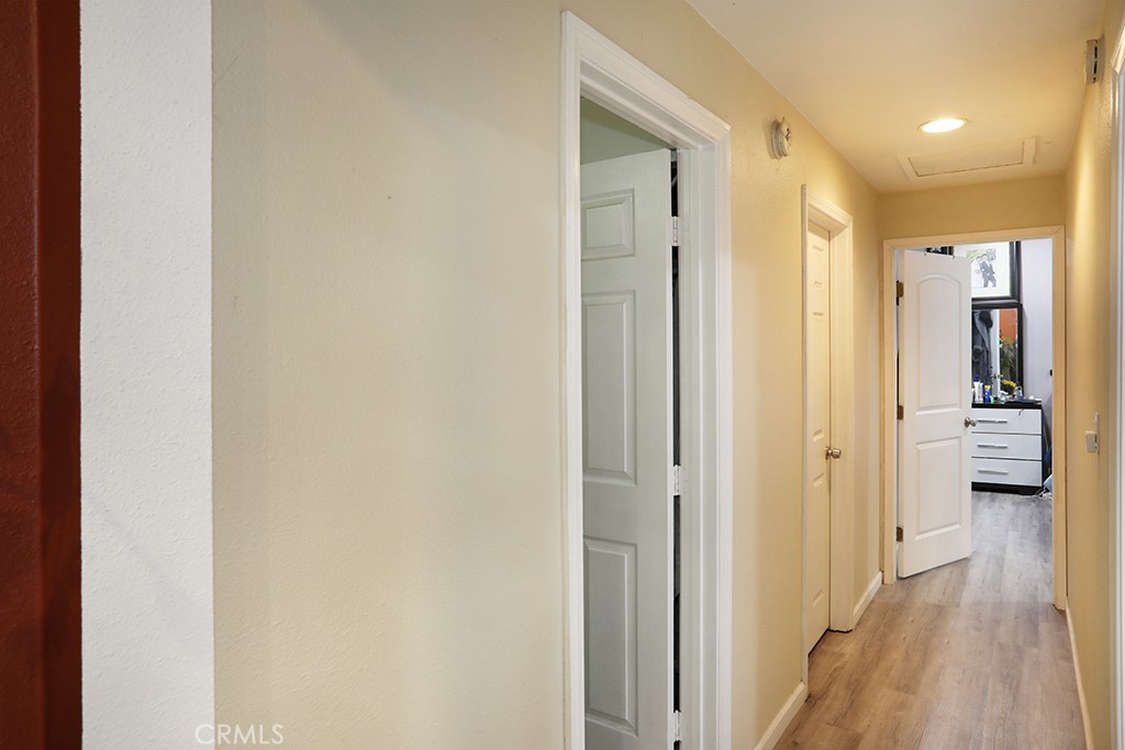 9802 Chanticleer Road Anaheim, CA 92804 - Photo 16 of 31 a view of a hallway with wooden floor