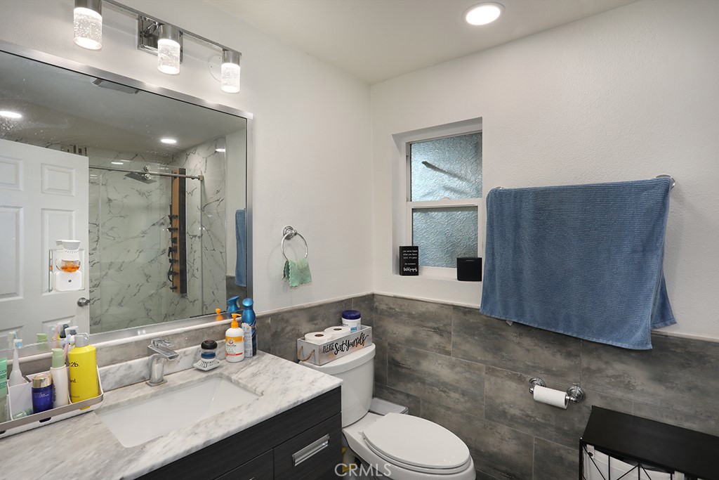 9802 Chanticleer Road Anaheim, CA 92804 - Photo 17 of 31 a bathroom with a sink vanity mirror and toilet