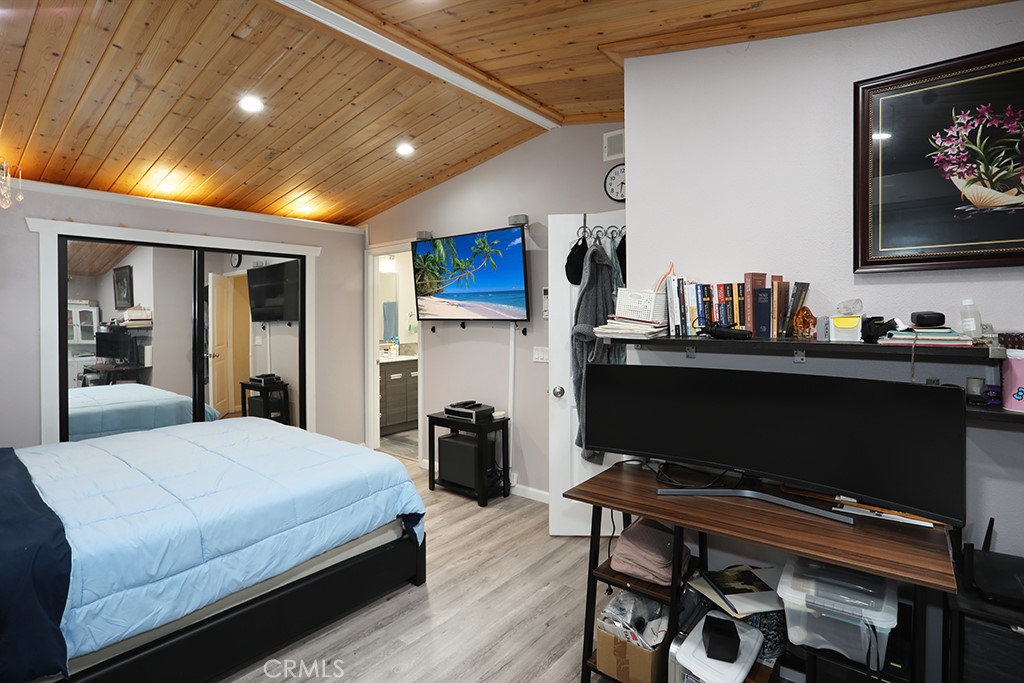 9802 Chanticleer Road Anaheim, CA 92804 - Photo 19 of 31 a bedroom with a bed and a flat screen tv