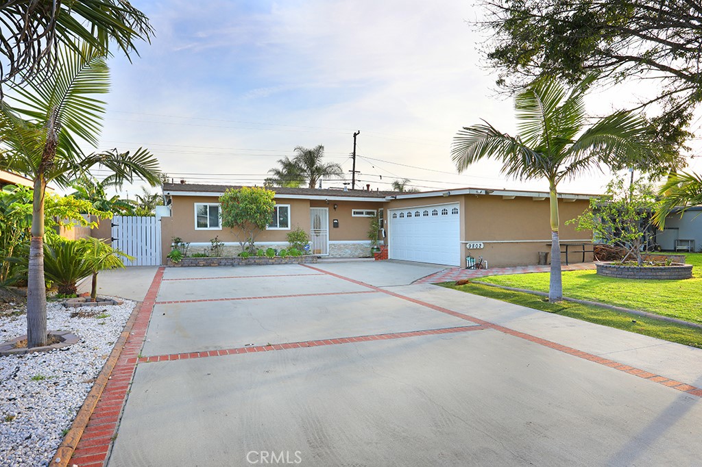 9802 Chanticleer Road Anaheim, CA 92804 - Photo 2 of 31 a view of a house with a yard and palm trees