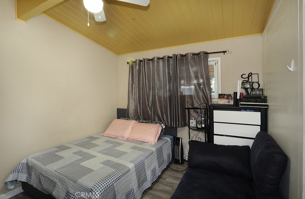 9802 Chanticleer Road Anaheim, CA 92804 - Photo 23 of 31 a bedroom with a bed and dresser with mirror