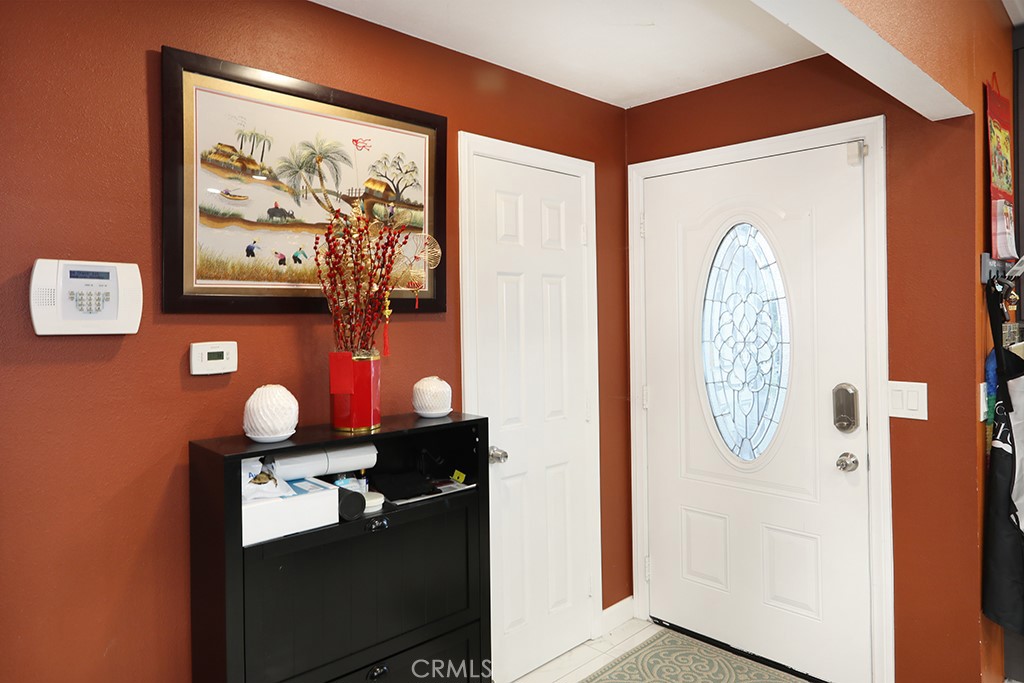 9802 Chanticleer Road Anaheim, CA 92804 - Photo 4 of 31 a room with painting on the wall and a potted plant