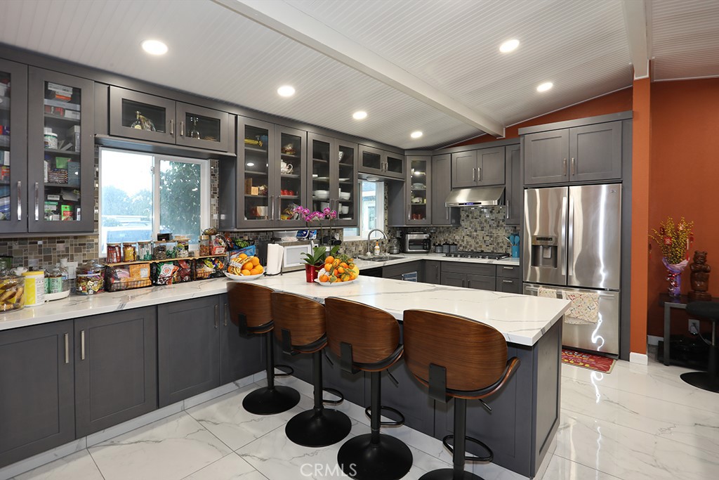 9802 Chanticleer Road Anaheim, CA 92804 - Photo 6 of 31 a kitchen with sink cabinets and stainless steel appliances