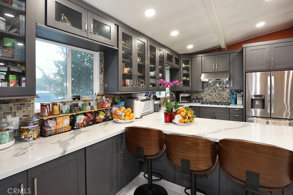 9802 Chanticleer Road Anaheim, CA 92804 - Photo 7 of 31 a kitchen with stainless steel appliances granite countertop a sink and chairs