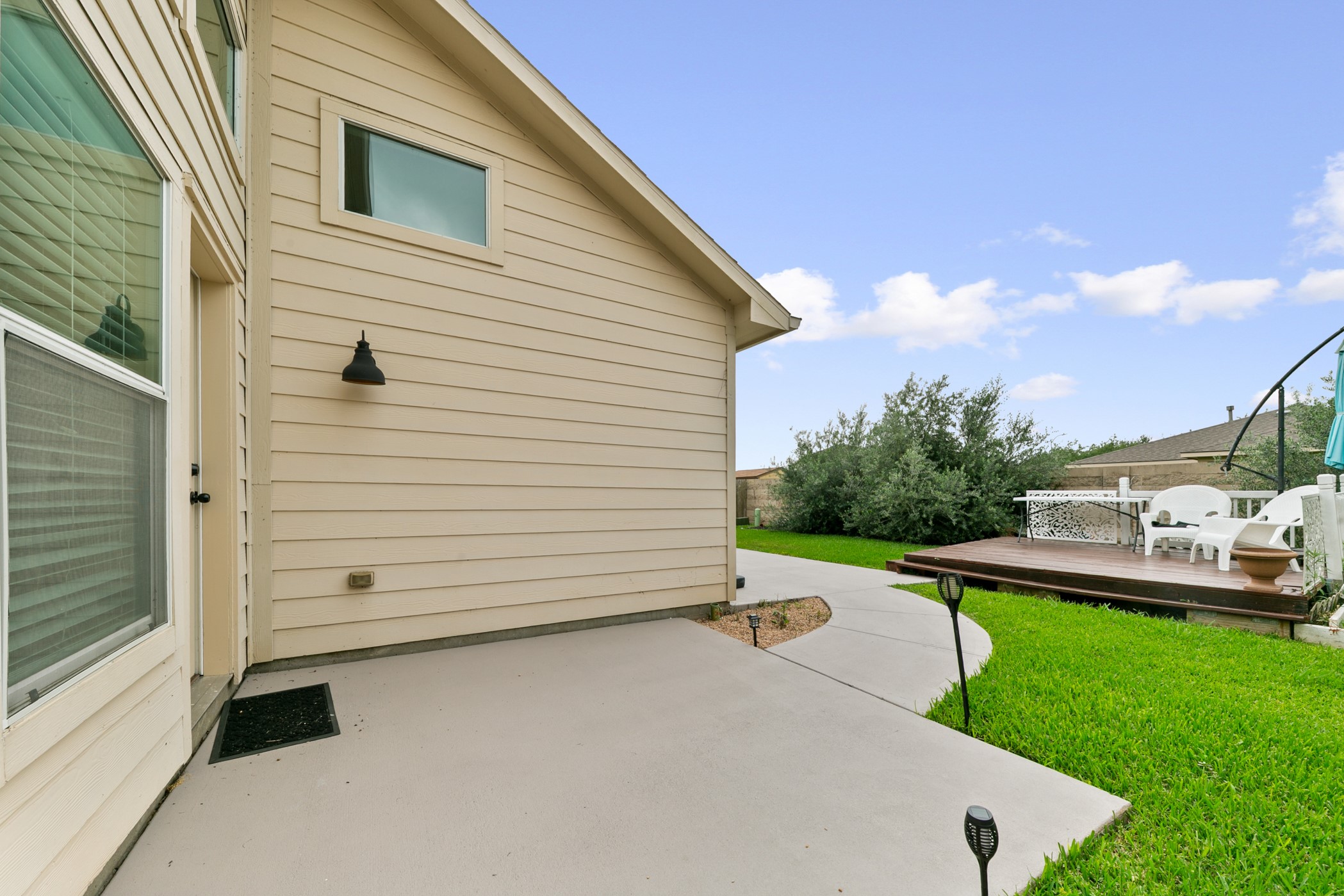 9438 Emerald Lakes Drive Rosharon, TX 77583 - Photo 25 of 36 a view of a white house with a yard
