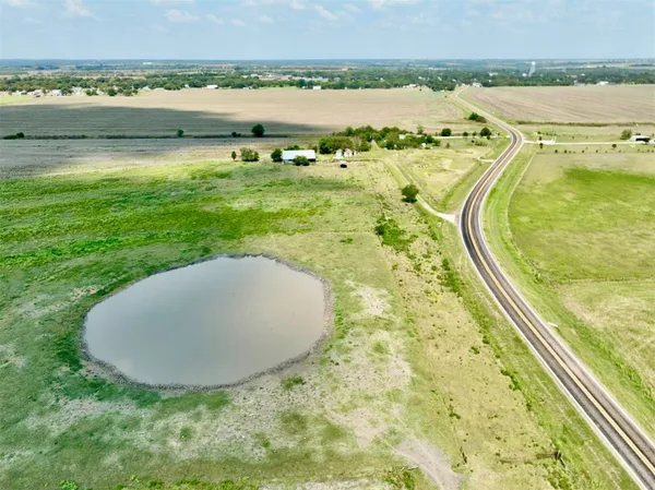 a view of a swimming pool with a yard and outdoor seating
