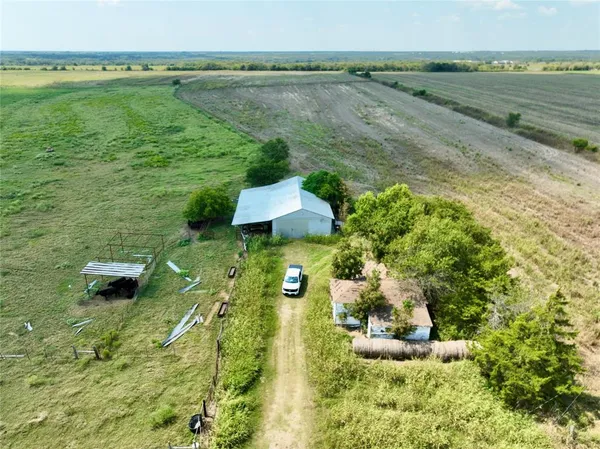 a aerial view of a house with a yard and lake view