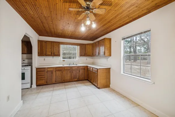 a large kitchen with a large window cabinets and stainless steel appliances