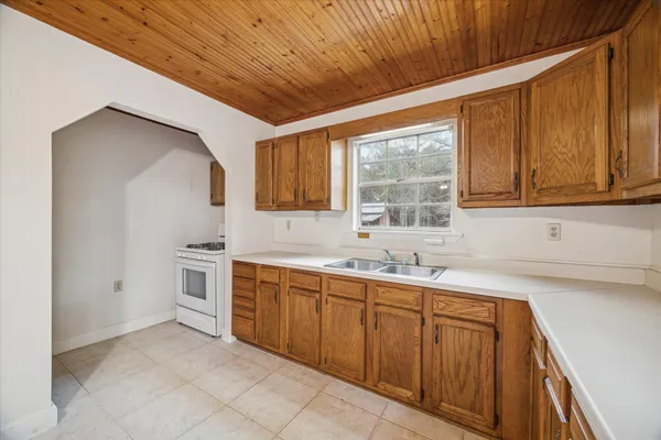 a kitchen with sink cabinets and window