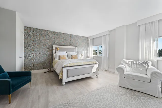 a bedroom with a bed couch and a window