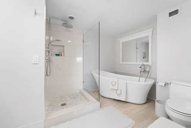a bathroom with a shower sink and mirror
