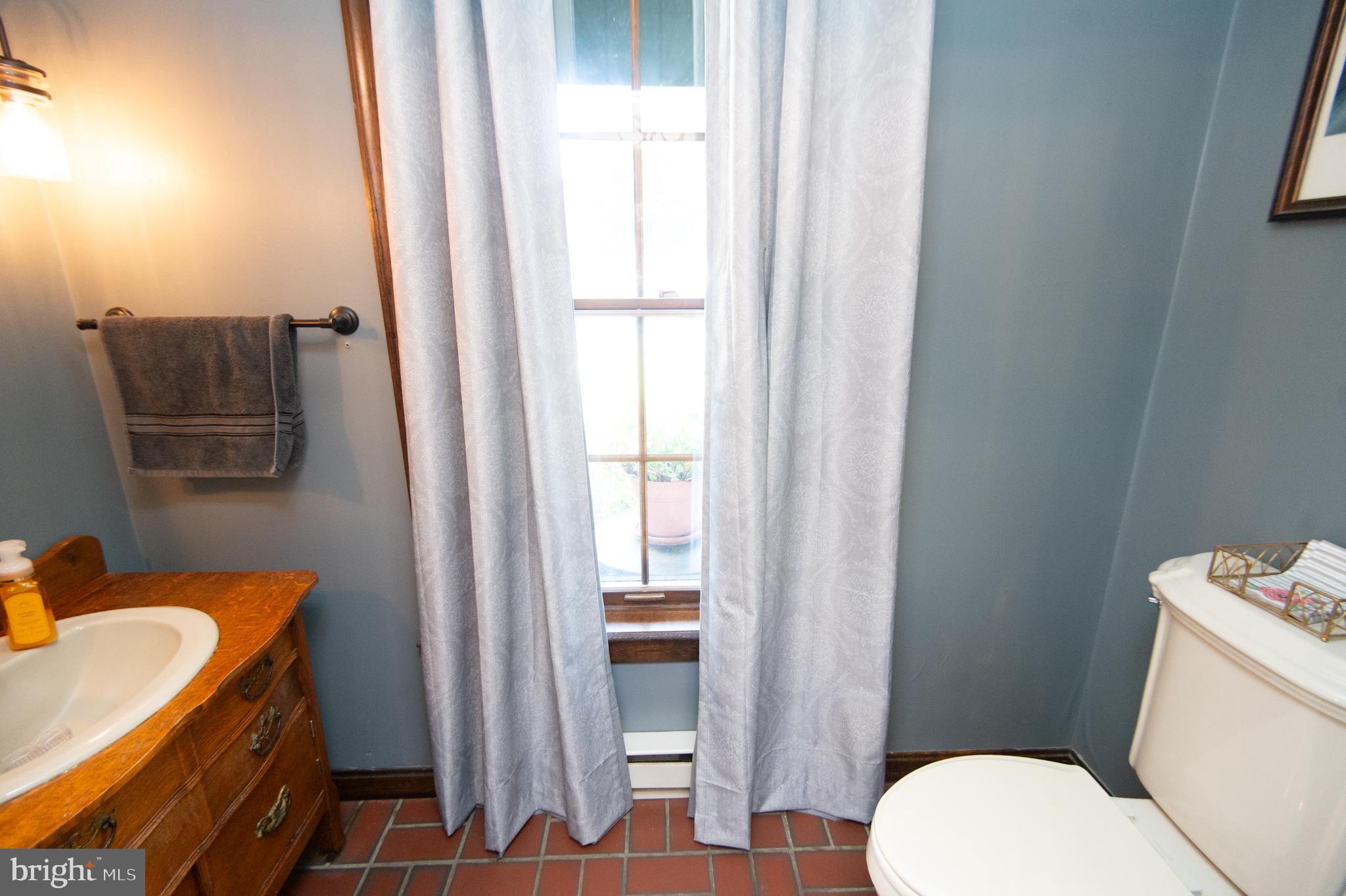 11 Shawnee Road Cambridge, MD 21613 - Photo 26 of 56 a bathroom with a sink toilet and vanity