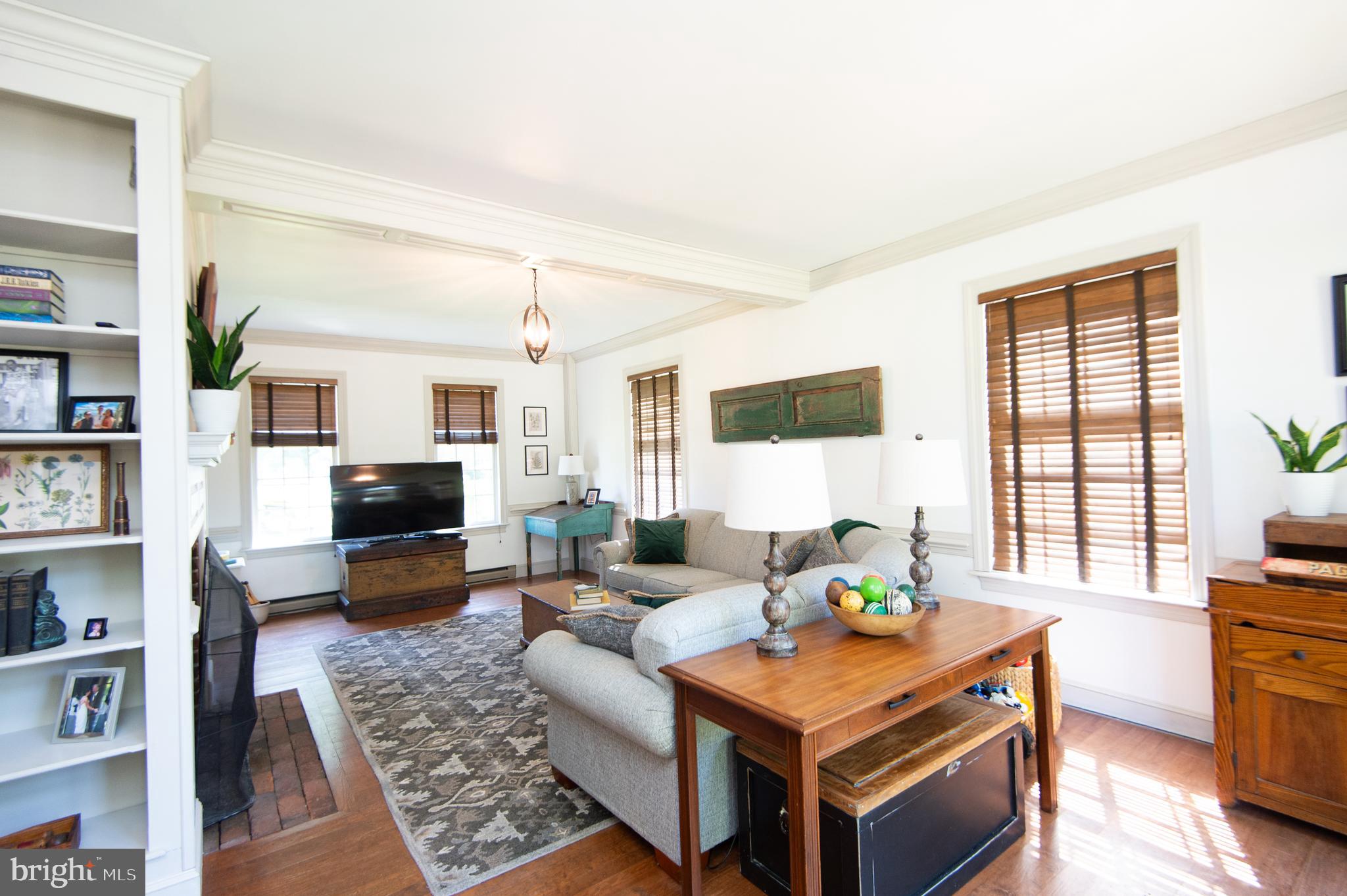 11 Shawnee Road Cambridge, MD 21613 - Photo 3 of 56 a living room with furniture a bookshelf and a flat screen tv