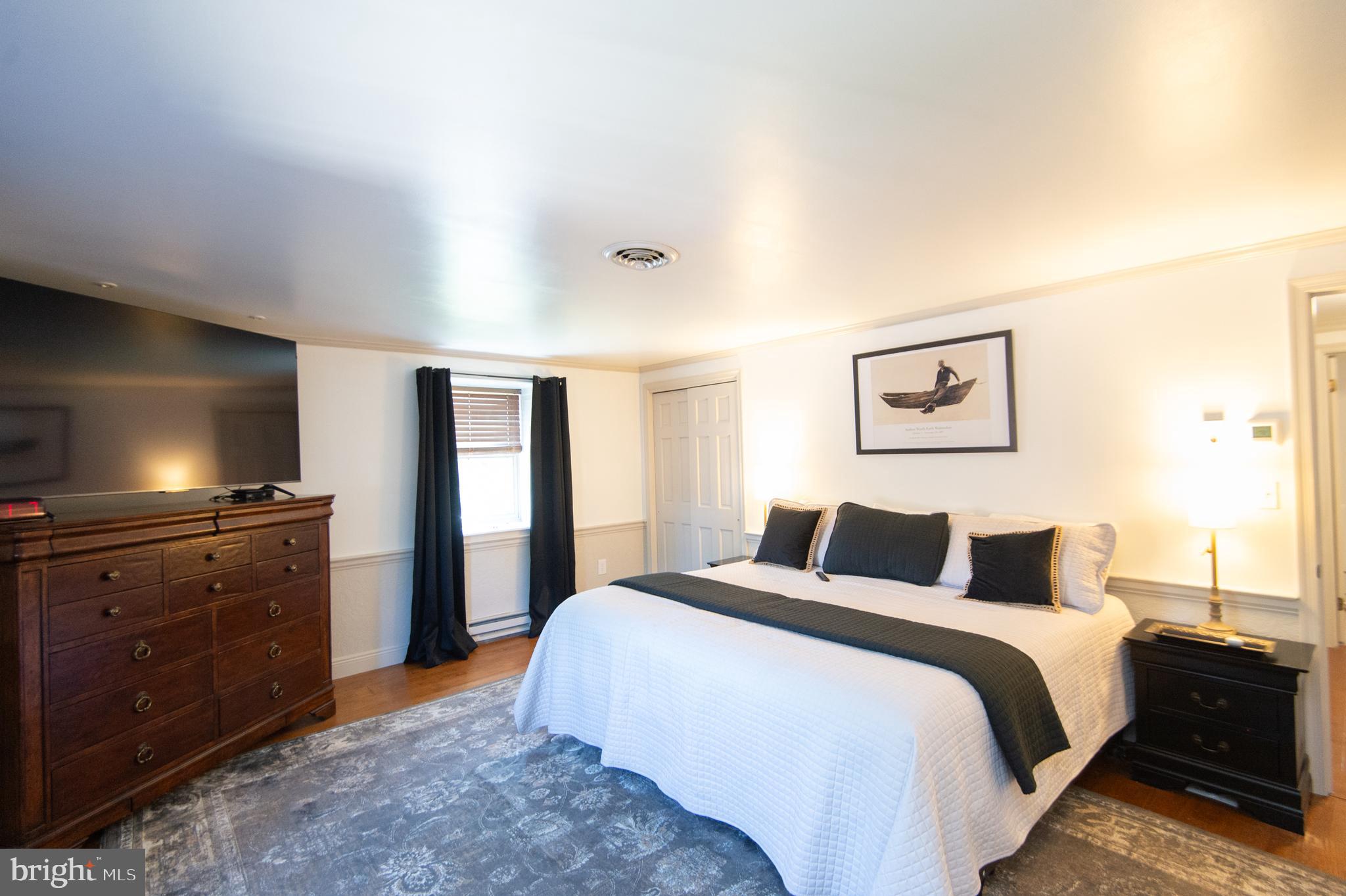 11 Shawnee Road Cambridge, MD 21613 - Photo 31 of 56 a bedroom with a bed and a chandelier