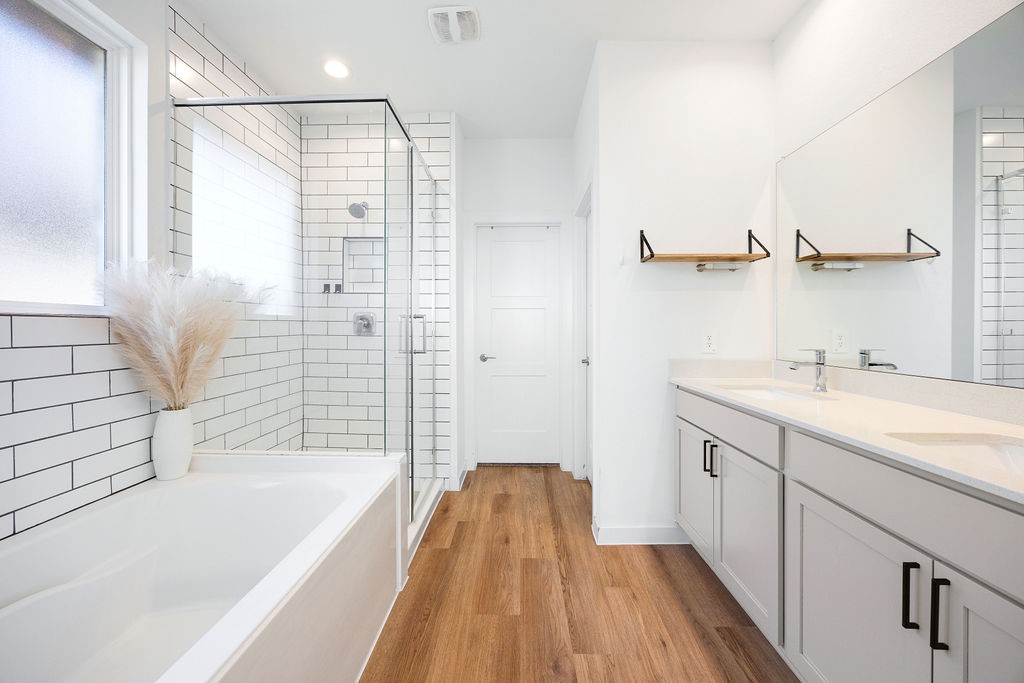 116 Solana Point Drive Katy, TX 77493 - Photo 7 of 31 The primary bedroom offers privacy and relaxation, with dual vanity sinks and a spacious walk-in closet