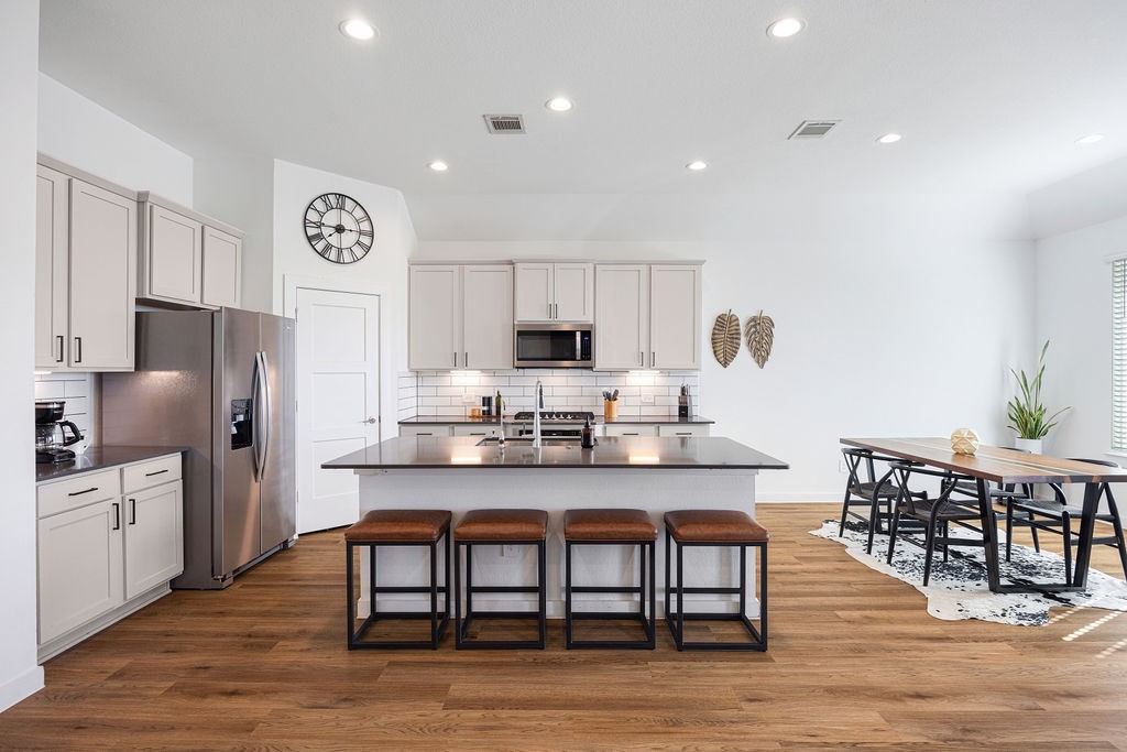 116 Solana Point Drive Katy, TX 77493 - Photo 26 of 31 The open floor plan flows seamlessly from the kitchen to the living room, ideal for the ins and outs of your everyday life.