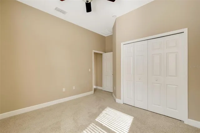 a view of a livingroom with a ceiling fan and wooden floor