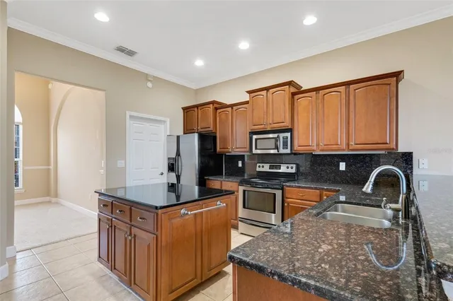 a kitchen with granite countertop a stove and a sink