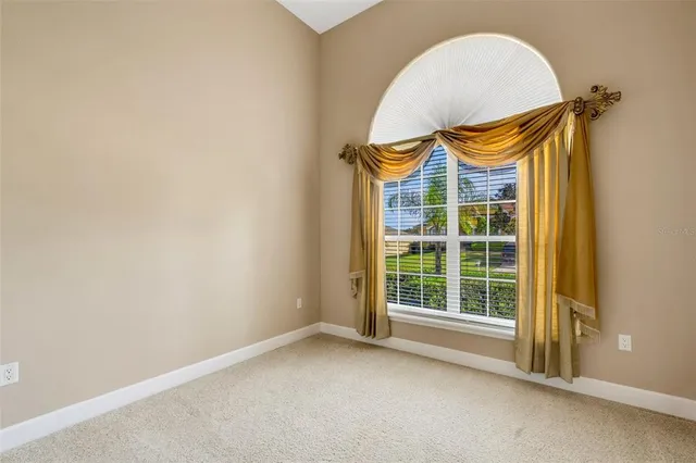a view of a livingroom with a floor to ceiling window and a couch