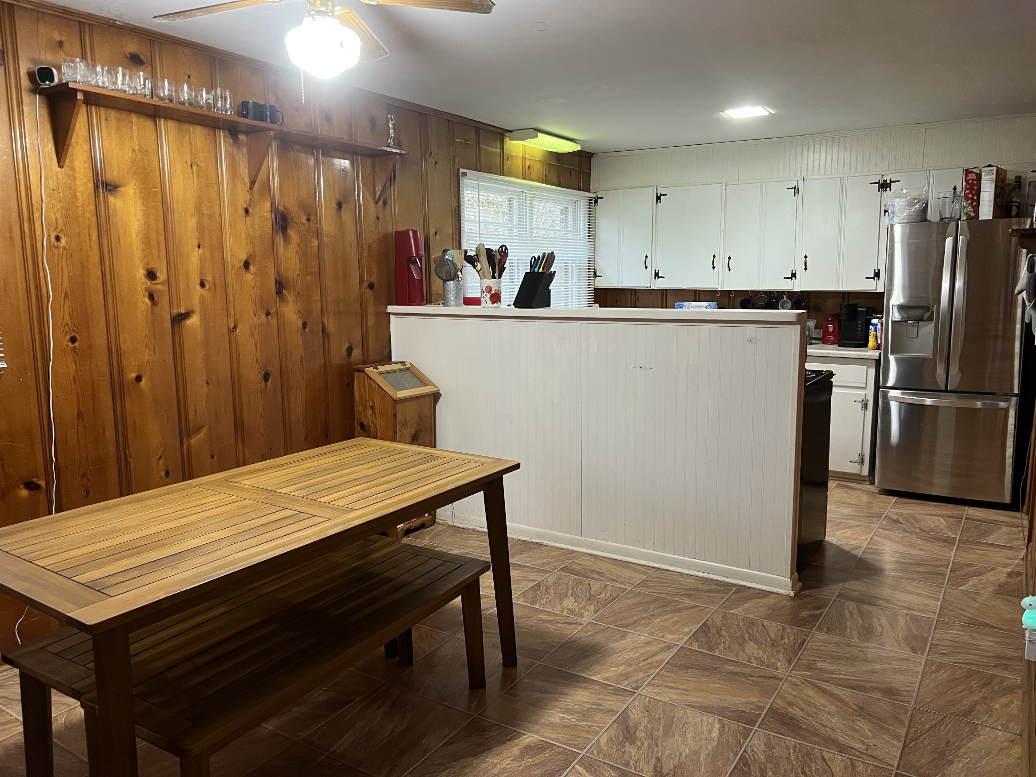 355 Chicken Creek Road Pulaski, TN 38478 - Photo 8 of 17 a kitchen with a table chairs refrigerator and microwave
