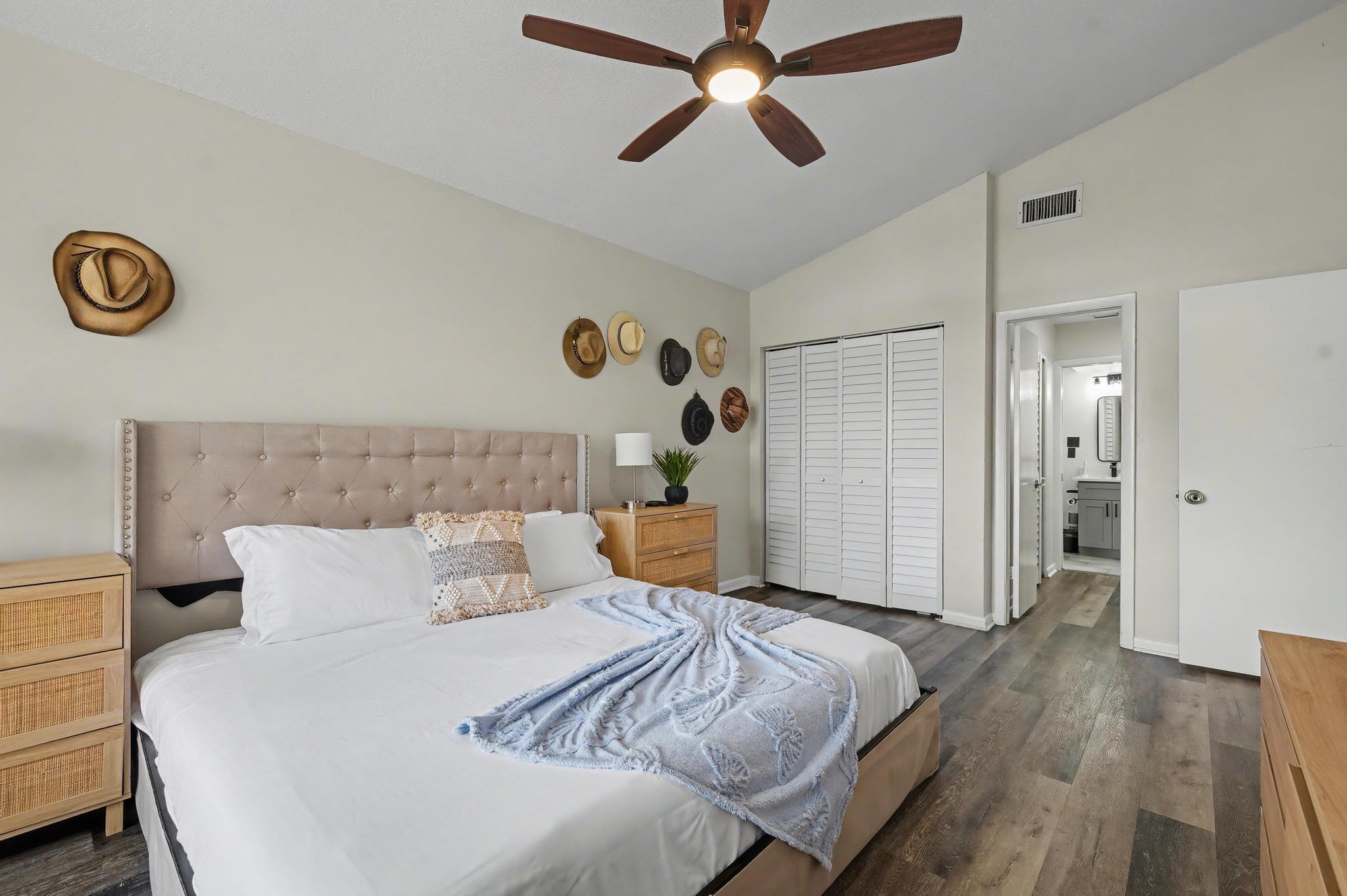 7855 Stanway Place Boca Raton, FL 33433 - Photo 12 of 24 a bedroom with a bed and a chandelier